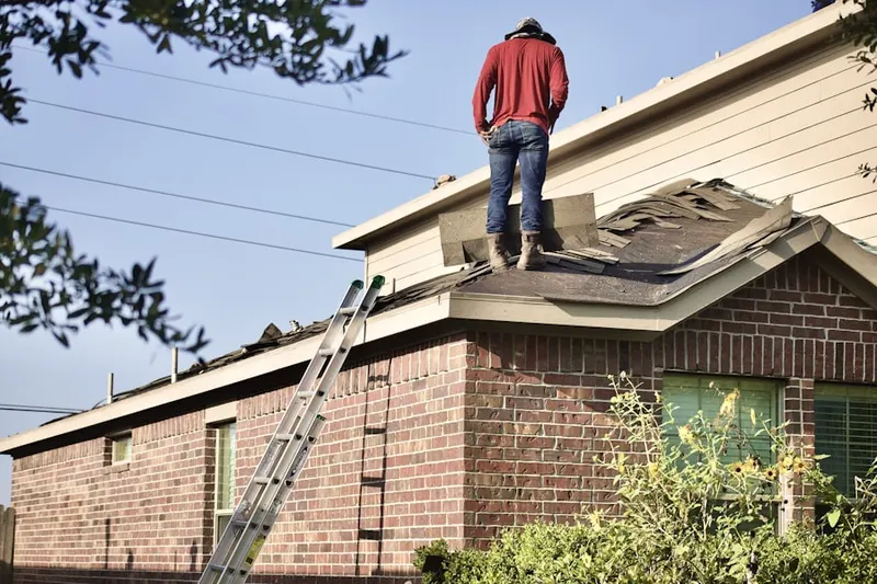 Professional roofer working on a residential roof in Dania